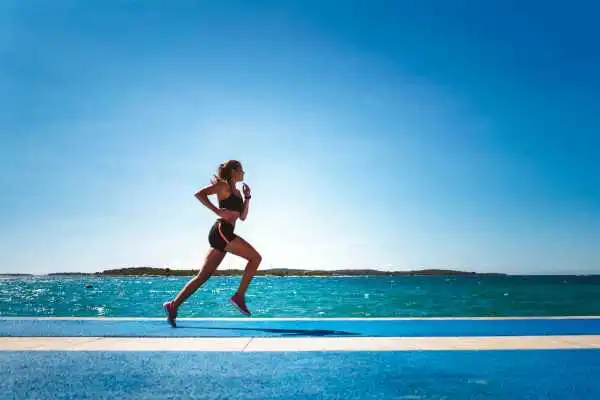 Woman running showing strong leg muscle Somerset